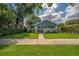 Quaint home with a beautifully maintained lawn, mature trees, and a welcoming front porch at 5301 N Central Ave, Tampa, FL 33603