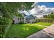 Charming home with a well-manicured lawn, mature trees, and a welcoming front porch, showcasing curb appeal at 5301 N Central Ave, Tampa, FL 33603