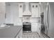 Modern kitchen featuring stainless steel appliances, white cabinetry, and decorative backsplash at 5301 N Central Ave, Tampa, FL 33603