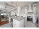 Open-concept kitchen featuring a center island, stainless steel appliances, and decorative flooring at 5301 N Central Ave, Tampa, FL 33603