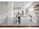 Bright kitchen featuring white cabinets, stainless steel appliances, island, and eye-catching tile floors at 5301 N Central Ave, Tampa, FL 33603