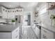 Charming kitchen with stainless appliances, granite countertops, decorative backsplash, and custom tile flooring at 5301 N Central Ave, Tampa, FL 33603