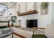 Bright living room showcasing a charming white brick fireplace with a wooden beam mantel and decorative accents at 5301 N Central Ave, Tampa, FL 33603