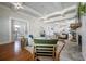 Cozy living area featuring hardwood floors, a brick fireplace, and open layout to the kitchen at 5301 N Central Ave, Tampa, FL 33603