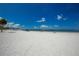 Picturesque beach with a wide expanse of white sand meeting the clear blue sea under a sunny sky at 6334 Spring Flower Dr # 24, New Port Richey, FL 34653