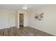 Bright bedroom featuring a ceiling fan, wood floors, a closet, and an attached bathroom for convenience at 6334 Spring Flower Dr # 24, New Port Richey, FL 34653