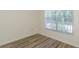 Bedroom showcasing light wood laminate flooring and a window with blinds at 6334 Spring Flower Dr # 24, New Port Richey, FL 34653