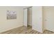 Bedroom featuring wood floors, a closet with sliding doors, and neutral walls, creating a peaceful atmosphere at 6334 Spring Flower Dr # 24, New Port Richey, FL 34653