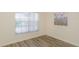 Well-lit bedroom with wood floors and blinds, providing a serene and private retreat within the home at 6334 Spring Flower Dr # 24, New Port Richey, FL 34653