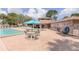 Relaxing community pool and hot tub area featuring a shaded table, comfortable lounge chairs and a convenient clubhouse at 6334 Spring Flower Dr # 24, New Port Richey, FL 34653