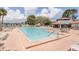 Bright community pool featuring a spacious deck, comfortable lounge chairs and an inviting adjacent clubhouse at 6334 Spring Flower Dr # 24, New Port Richey, FL 34653