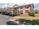 Two-story condo building featuring a covered carport, brick accents, and well-maintained landscaping at 6334 Spring Flower Dr # 24, New Port Richey, FL 34653
