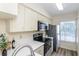 Kitchen featuring stainless steel appliances, white cabinetry, and quartz countertops at 6334 Spring Flower Dr # 24, New Port Richey, FL 34653