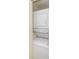 Efficiently stacked, white washer and dryer unit inside a closet for space-saving laundry convenience at 6334 Spring Flower Dr # 24, New Port Richey, FL 34653