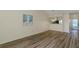 Open-concept living and dining area with hardwood floors, a view to kitchen, and vaulted ceilings at 6334 Spring Flower Dr # 24, New Port Richey, FL 34653