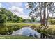 Scenic view of the community pond and recreation area on a sunny day at 6334 Spring Flower Dr # 24, New Port Richey, FL 34653
