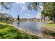 Scenic pond with a fountain, surrounded by lush greenery and residential buildings at 6334 Spring Flower Dr # 24, New Port Richey, FL 34653