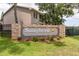 Sunnybrook community entrance featuring a brick and stone sign with mature landscaping at 6334 Spring Flower Dr # 24, New Port Richey, FL 34653