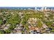 Expansive aerial view of a residential neighborhood with lush trees and a coastal city skyline in the background at 634 6Th N St, St Petersburg, FL 33701