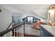Spacious attic bedroom with sloped ceilings, bed, desk, and comfortable seating area at 634 6Th N St, St Petersburg, FL 33701