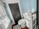 Cozy bathroom featuring a toilet and modern storage cabinet on wood-look flooring and blue painted walls at 634 6Th N St, St Petersburg, FL 33701