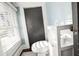 Small bathroom boasts a toilet, linen storage, and a window with white blinds at 634 6Th N St, St Petersburg, FL 33701