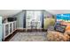 Bedroom featuring a blue chair, side table, and vintage dresser with integrated study area at 634 6Th N St, St Petersburg, FL 33701
