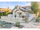 Quaint home featuring a white picket fence, landscaping, and an inviting covered front porch at 634 6Th N St, St Petersburg, FL 33701