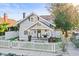 Charming two-story home featuring a white picket fence and a cozy front porch with tasteful decor at 634 6Th N St, St Petersburg, FL 33701