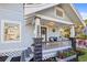 Charming front porch with stone columns, house number, and cozy seating area, surrounded by lush landscaping at 634 6Th N St, St Petersburg, FL 33701