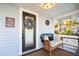 Cozy front porch featuring a wicker bench with decorative pillows and a charming welcome wreath on the door at 634 6Th N St, St Petersburg, FL 33701