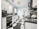 Bright kitchen features white cabinetry with black countertops and black and white checkered flooring at 634 6Th N St, St Petersburg, FL 33701