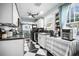 Bright kitchen features black appliances, white cabinetry, and black and white checkered flooring at 634 6Th N St, St Petersburg, FL 33701