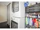 Functional laundry area features a stacked washer/dryer and shelving for storage at 634 6Th N St, St Petersburg, FL 33701