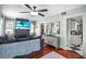 Bright living room with a decorative fireplace, hardwood floors, and an open doorway to the kitchen at 634 6Th N St, St Petersburg, FL 33701