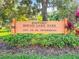 Wooden sign for Historic Round Lake Park in St. Petersburg, surrounded by lush greenery and flowers at 634 6Th N St, St Petersburg, FL 33701
