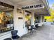 Unique storefront with glass art gallery, a coffee bar + cafe, and chairs for seating at 634 6Th N St, St Petersburg, FL 33701