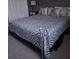 Stylish bedroom boasts a metallic bed frame and decorative zebra-striped bedding at 6615 Vanda Ln, Land O Lakes, FL 34637