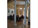 Elegant dining room featuring a wood table, chandelier, and natural light from multiple windows at 6615 Vanda Ln, Land O Lakes, FL 34637