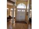 Grand entrance featuring a foyer with high ceilings, a view of the dining room, and a double-door entry at 6615 Vanda Ln, Land O Lakes, FL 34637