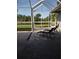 Enjoy outdoor living with this screened-in patio and beautiful views of the lush green surroundings and tranquil pond at 6615 Vanda Ln, Land O Lakes, FL 34637
