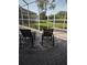 Relaxing screened lanai with comfortable lounge chairs and serene backyard views at 6615 W Vanda Ln, Land O Lakes, FL 34637