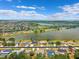Expansive aerial view of neighborhood homes near a lake, featuring a glimpse of distant cityscape at 6724 Clair Shore Dr, Apollo Beach, FL 33572