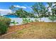 Well-maintained backyard with white fence, banana trees, and manicured landscaping at 6724 Clair Shore Dr, Apollo Beach, FL 33572