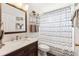 The bathroom includes a wood vanity, a mirror, and a shower with a curtain at 6724 Clair Shore Dr, Apollo Beach, FL 33572