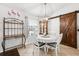 Charming dining area with a decorative light fixture, round table and chairs, and a sliding barn door at 6724 Clair Shore Dr, Apollo Beach, FL 33572