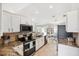Well-lit kitchen featuring white cabinets, stainless steel appliances, granite countertops, and tile flooring at 6724 Clair Shore Dr, Apollo Beach, FL 33572