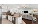 Open-concept kitchen and living room area featuring stainless steel appliances and comfortable furnishings at 6724 Clair Shore Dr, Apollo Beach, FL 33572