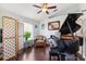 Cozy living area showcasing dark hardwood flooring, natural light, and a grand piano for entertainment at 6724 Clair Shore Dr, Apollo Beach, FL 33572