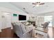 Inviting living room featuring a fireplace, hardwood floors, and sliding glass doors to a screened in patio and pool at 6724 Clair Shore Dr, Apollo Beach, FL 33572